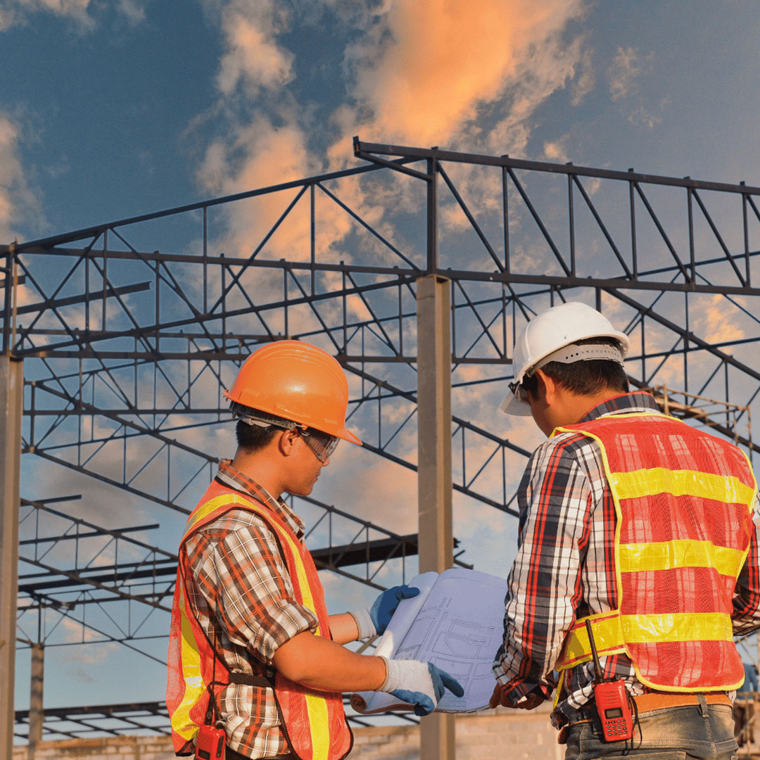 2 men looking at commercial roofing plans
